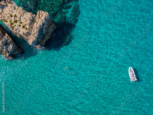 Aerial view of the Riaci rocks, Riaci beach near Tropea, Calabria. Italy. Beaches and crystal clear sea. A dinghy moored and swimmers who swim and snorkel © Naeblys