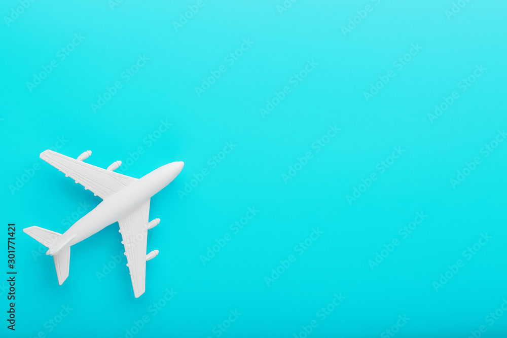 White passenger plane on a blue background. Free space.