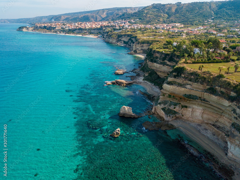 Aerial view of promontory of the Calabrian coast overlooking the sea, town of Riaci, Tropea, Calabria, Italy. Beaches and crystal clear sea. Paths that run along headlands to admire the coast