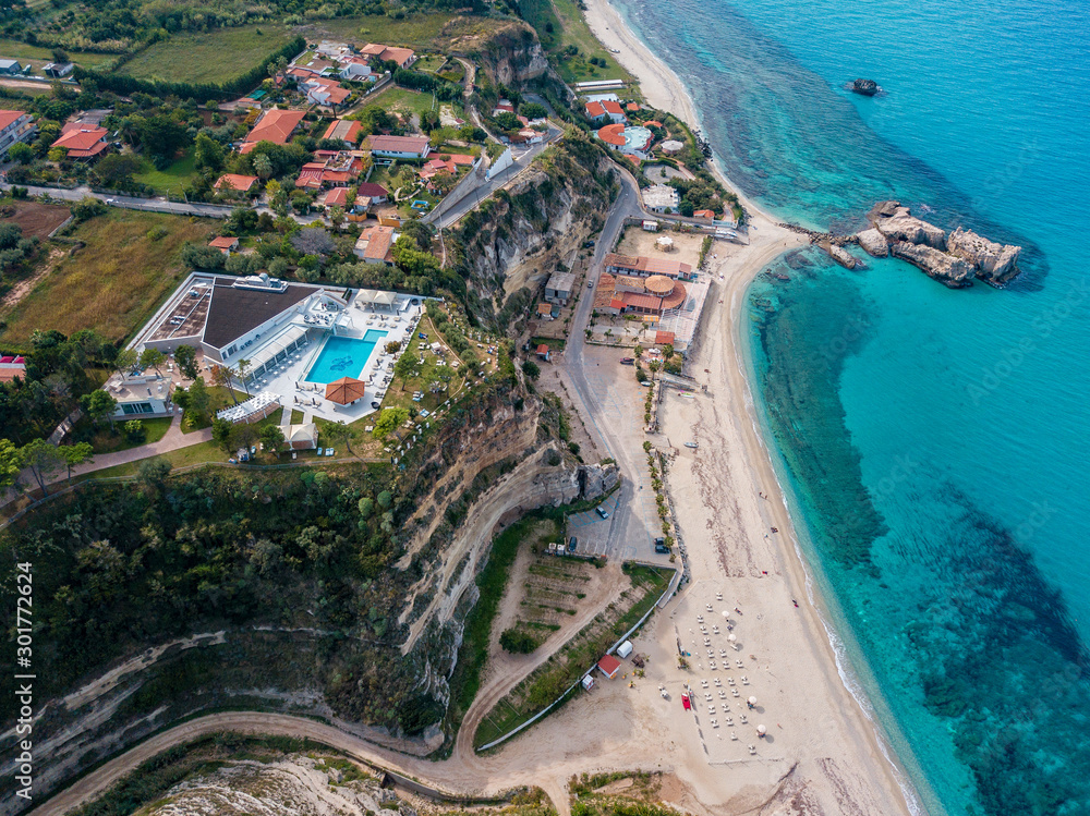 Aerial view of the Calabrian coast, cliffs overlooking the crystal clear sea and luxury villas. Locality of Riaci south of Tropea. Calabria. Italy
