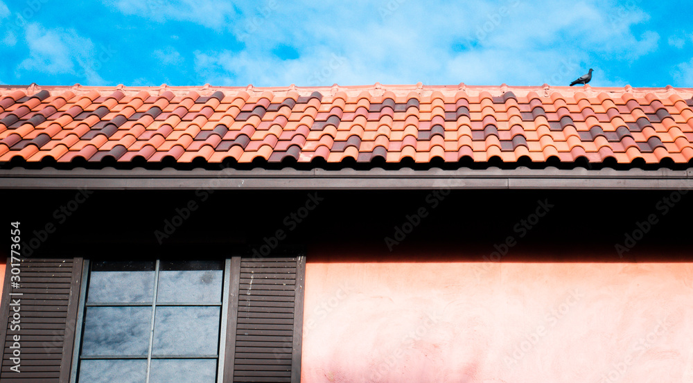 roof top on sky background. Close up of brown clay roof tiles. Red old dirty roof. Old roof tiles. Close-up aerial view of the traditional red Mediterranean roofs with blue summer sky in the old town roof top on sky background. Close up of brown clay roof tiles. Red old dirty roof. Old roof tiles. Close-up aerial view of the traditional red Mediterranean roofs with blue summer sky in the old town