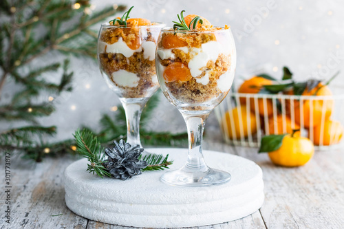 Citrus trifle with fresh tangerines. Christmas portioned dessert on the festive table.