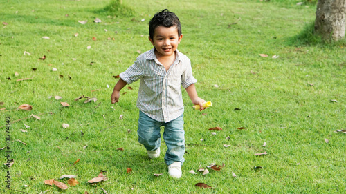 Asian Children 2 year old playing in the garden outdoor holiday kid concept.