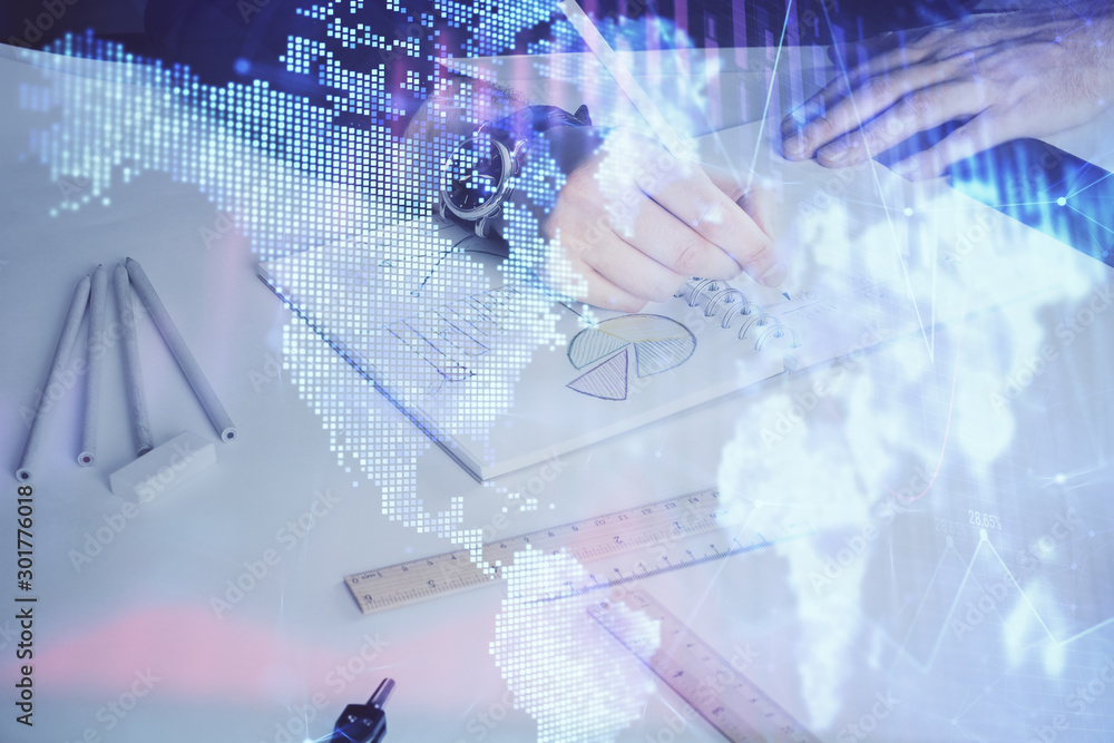 Double exposure of man's hands writing notes of stock market with forex chart. Double exposure of man's hands writing notes of stock market with forex chart.