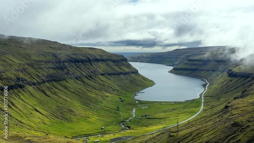 Spectacular views of the scenic fjords on the Faroe Islands with cloud-covered mountains.