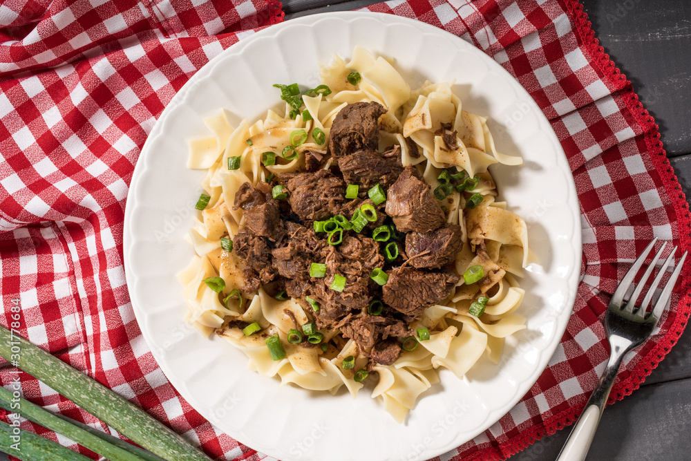 Stewed beef with tagliatelle pasta.