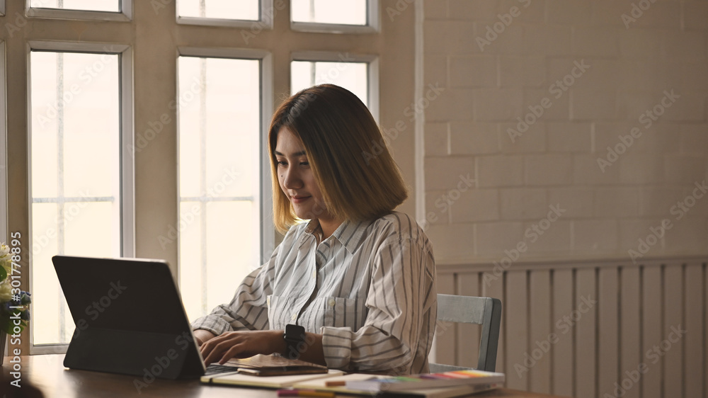 Young creative woman working with digital tablet. Young creative woman working with digital tablet.
