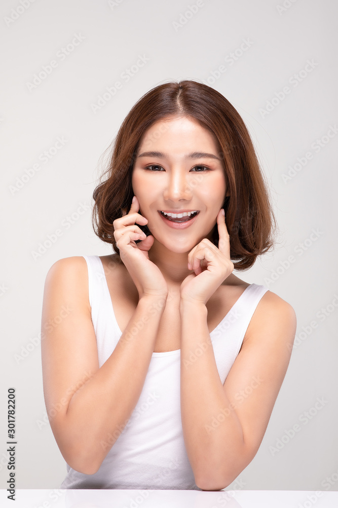 Beautiful Asian young woman touching soft cheek smile with clean and fresh skin Happiness and cheerful with positive emotional,isolated on gray background,Beauty and Cosmetics Concept Beautiful Asian young woman touching soft cheek smile with clean and fresh skin Happiness and cheerful with positive emotional,isolated on gray background,Beauty and Cosmetics Concept