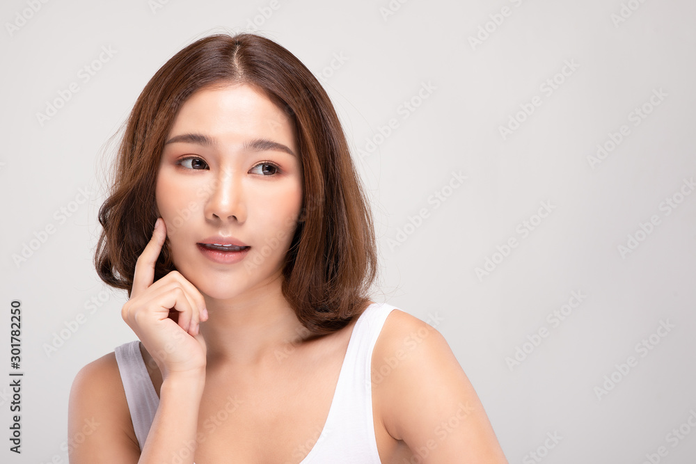 Beautiful Asian young woman touching soft cheek smile with clean and fresh skin Happiness and cheerful with positive emotional,isolated on gray background,Beauty and Cosmetics Concept Beautiful Asian young woman touching soft cheek smile with clean and fresh skin Happiness and cheerful with positive emotional,isolated on gray background,Beauty and Cosmetics Concept
