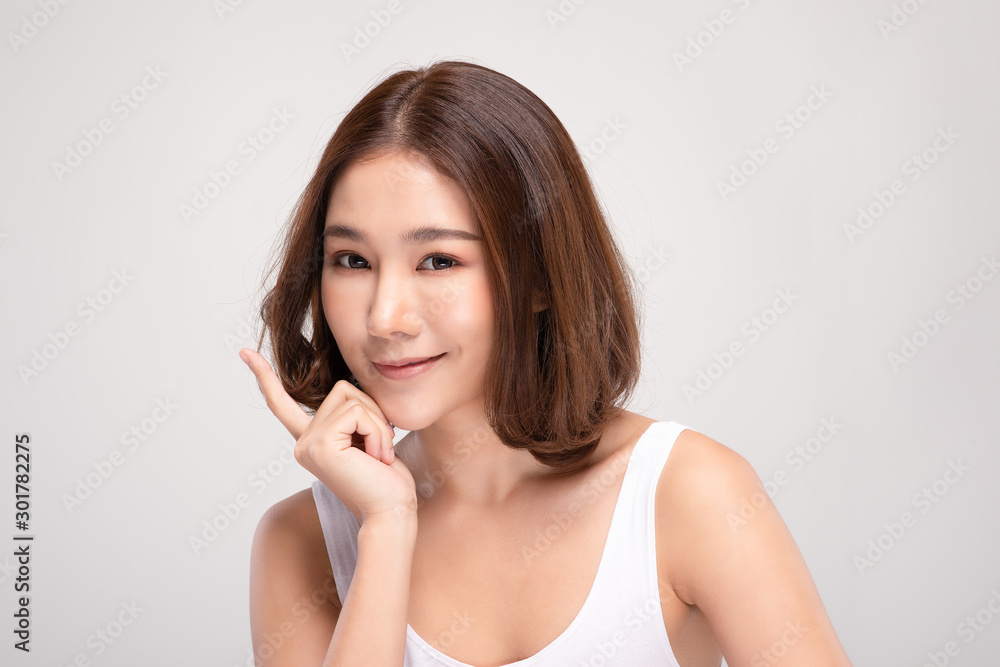 Beautiful Asian young woman touching soft cheek smile with clean and fresh skin Happiness and cheerful with positive emotional,isolated on gray background,Beauty and Cosmetics Concept Beautiful Asian young woman touching soft cheek smile with clean and fresh skin Happiness and cheerful with positive emotional,isolated on gray background,Beauty and Cosmetics Concept