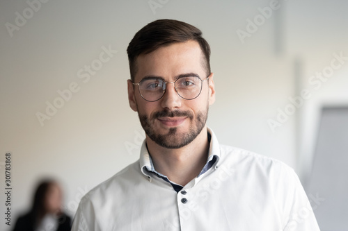 Portrait of millennial businessman posing looking at camera