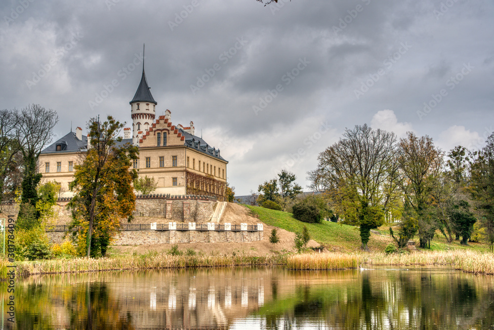 Castle reflecting in lake below it in autumn, Czech Redun