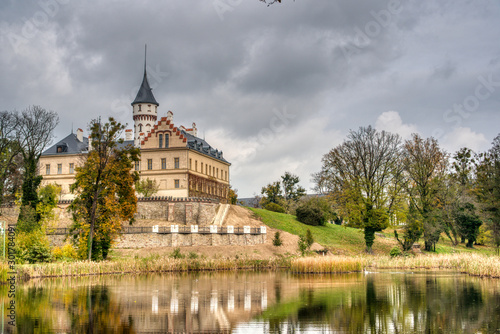 Castle reflecting in lake below it in autumn, Czech Redun