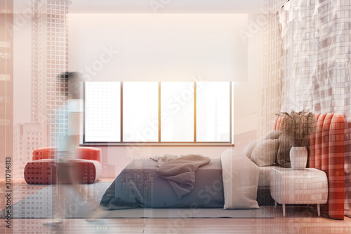 Woman in white bedroom with armchair