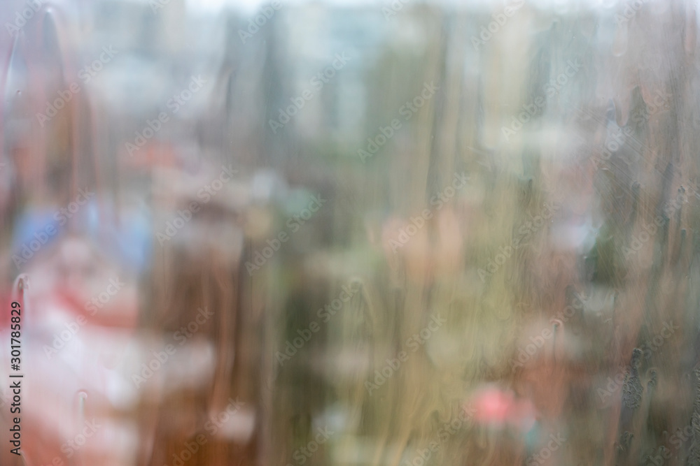 Watercolor paint on a window pane on a city background Watercolor paint on a window pane on a city background
