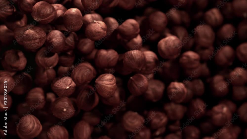 Super Slow Motion Shot of Hazelnuts Flies After Being Exploded against Black Background, 1000fps. Super Slow Motion Shot of Hazelnuts Flies After Being Exploded against Black Background, 1000fps.