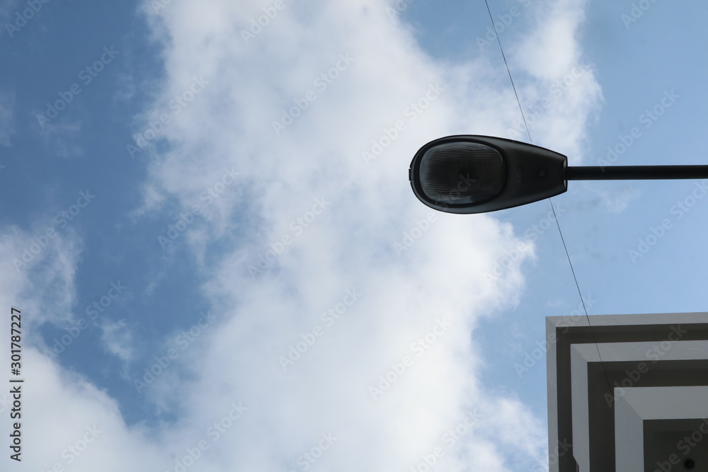 Building and street light with sky on the background. Low angel view Building and street light with sky on the background. Low angel view
