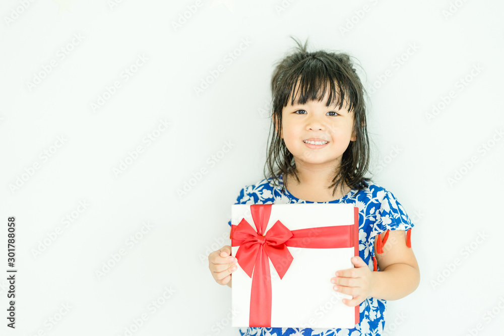 Little asian girl smile and holding red gift box on white background.child holding gift box. Little asian girl smile and holding red gift box on white background.child holding gift box.