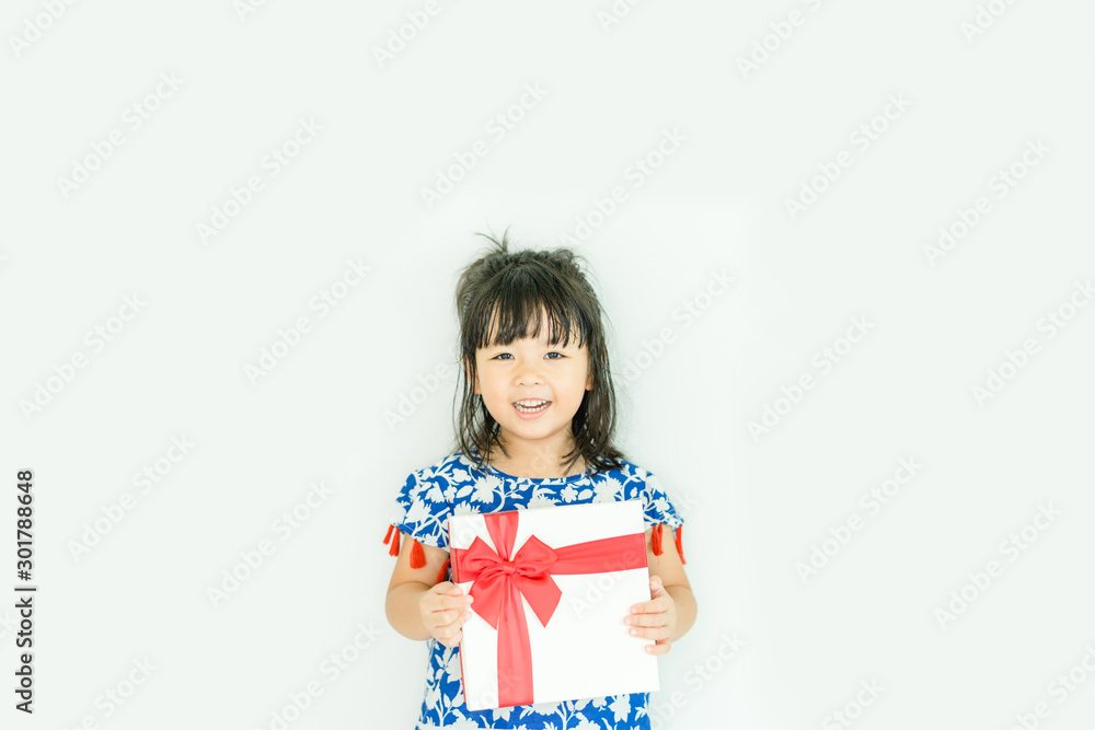 Little asian girl smile and holding red gift box on white background.child holding gift box. Little asian girl smile and holding red gift box on white background.child holding gift box.