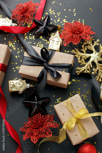 Christmas gifts, presents, ornaments on black holiday background. Merry Christmas luxury stylish greeting card, frame. Winter xmas holiday theme. Happy New Year.
