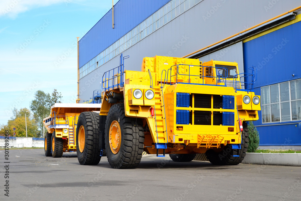 Giant mining dump truck, after being discharged from the conveyor, is tested at the factory test site. Heavy-duty truck manufacture by the heavy vehicle plant. Giant mining dump truck, after being discharged from the conveyor, is tested at the factory test site. Heavy-duty truck manufacture by the heavy vehicle plant.