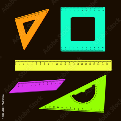 Set of colored school rulers on a black background