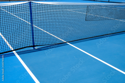 Blue tennis court with tennis net © Sathaporn