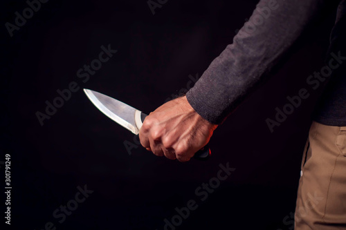 Man holds knife. People, family violence and crime concept