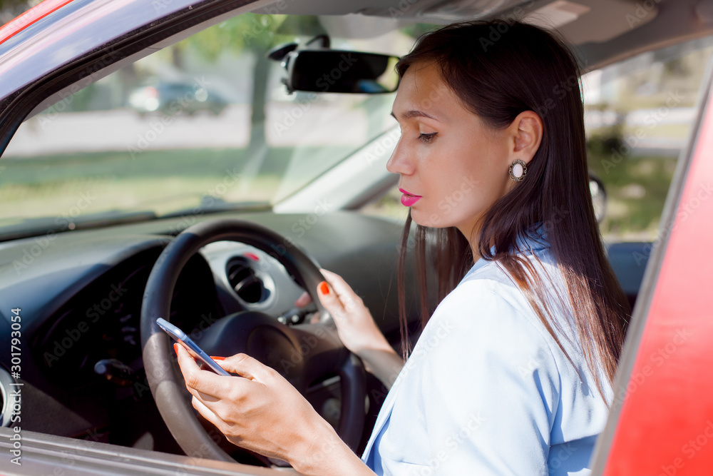 Driver woman driving a car distracted on the phone Driver woman driving a car distracted on the phone