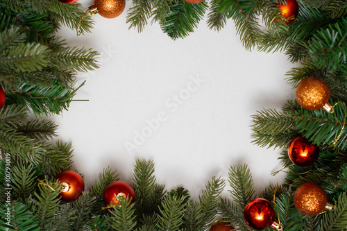 Christmas composition frame. Christmas  decoration spruce paws with golden balls on white background.
