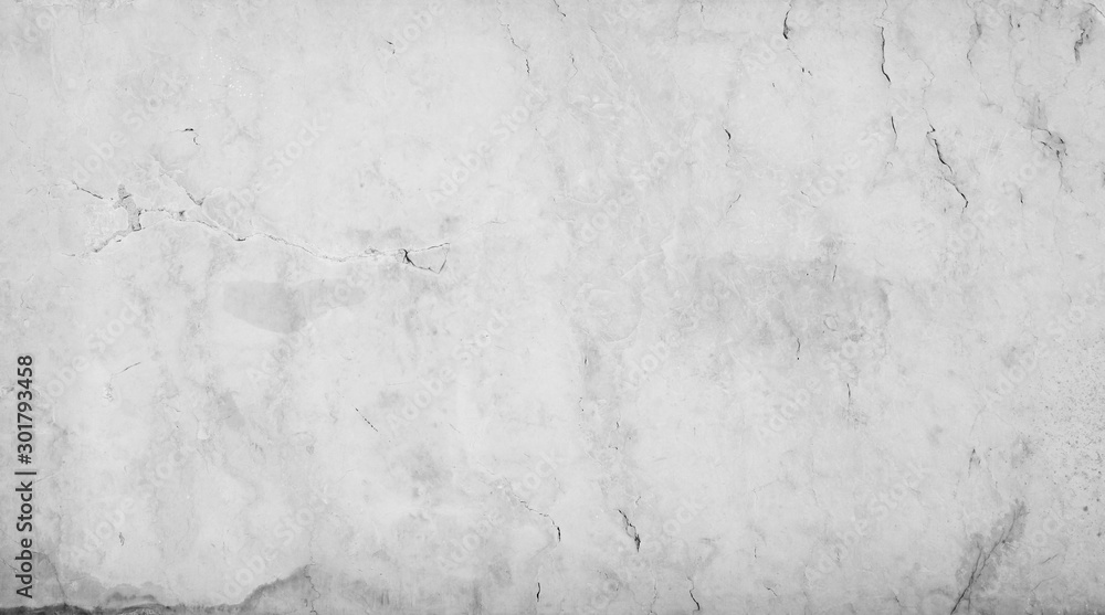 Fototapeta premium Close-up of an aged and cracked smooth natural marble stone wall or flooring. High resolution full frame textured background in black and white.