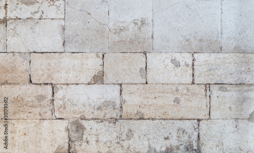 Close-up of an old and weathered wall or flooring made of cement blocks. High resolution full frame textured background.