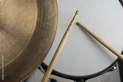 Musical instruments close up. Beautiful snare drum/ hi-hat cymbals with drummer holding drumsticks 