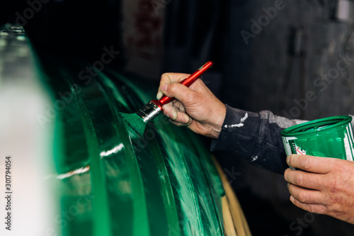 Painting a boat in green colour photo