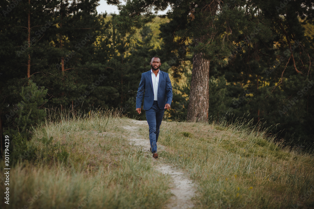 african man in a business suit in the forest african man in a business suit in the forest