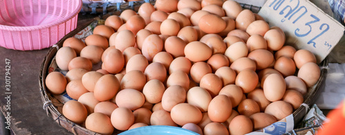 chicken fresh eggs, white and beige, on display in a local farmers market, in order in carton, ready to be sold, Egg panels sold in the fresh market. Songkhla Province, Thailand photo