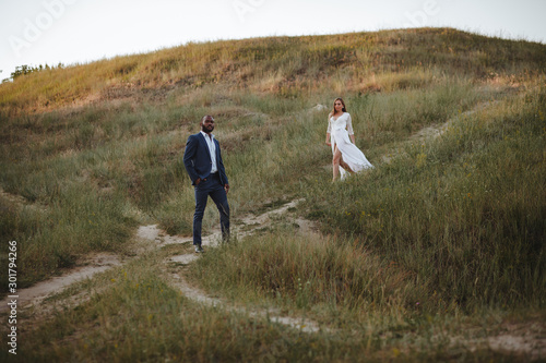 beautiful mixed couple of newlyweds