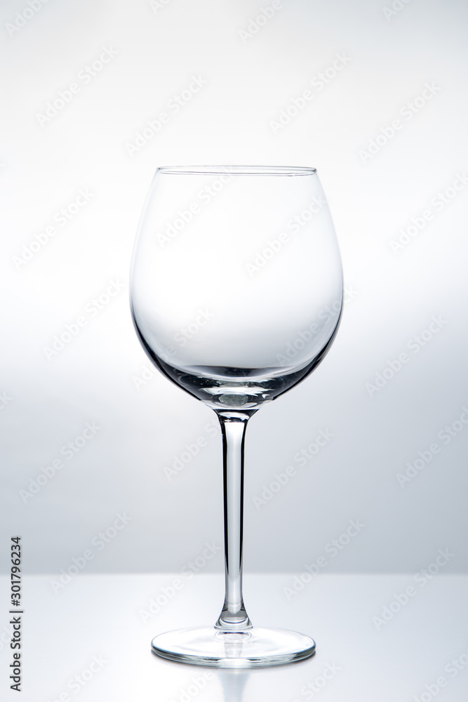 Elegant silhouette of an empty wine glass on a white background. Studio shot Elegant silhouette of an empty wine glass on a white background. Studio shot