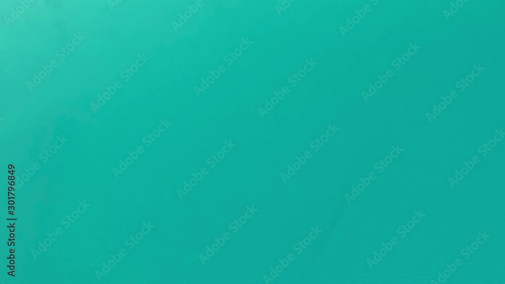 Aerial view: a top view of the waves on a high-altitude lake with clear turquoise water Aerial view: a top view of the waves on a high-altitude lake with clear turquoise water