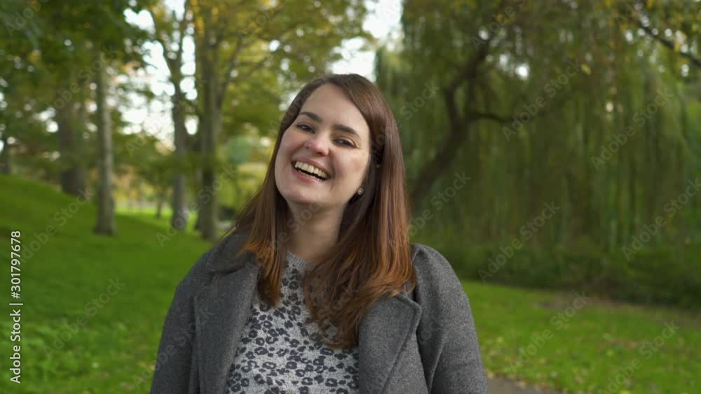 Smiling Portrait of Beautiful Brazilian woman in a park, in England. Smiling Portrait of Beautiful Brazilian woman in a park, in England.