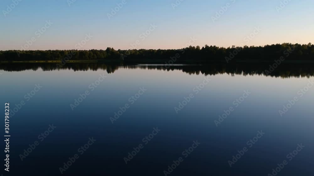 Aerial view: a large lake near a vast forest on a summer day in Russia. Vast expanses of Russia Aerial view: a large lake near a vast forest on a summer day in Russia. Vast expanses of Russia