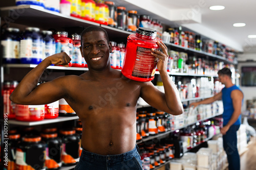 Strong bare to waist African man showing muscles