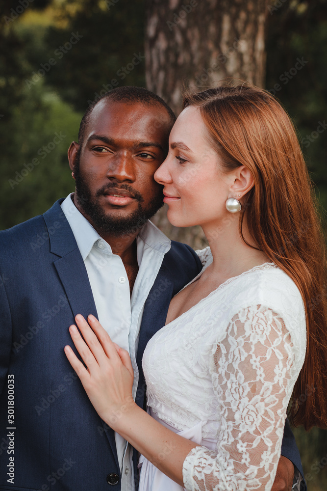 happy and beautiful mixed ethnicity couple with beautiful afro American man and cheerful europian woman loking in different directions happy and beautiful mixed ethnicity couple with beautiful afro American man and cheerful europian woman loking in different directions