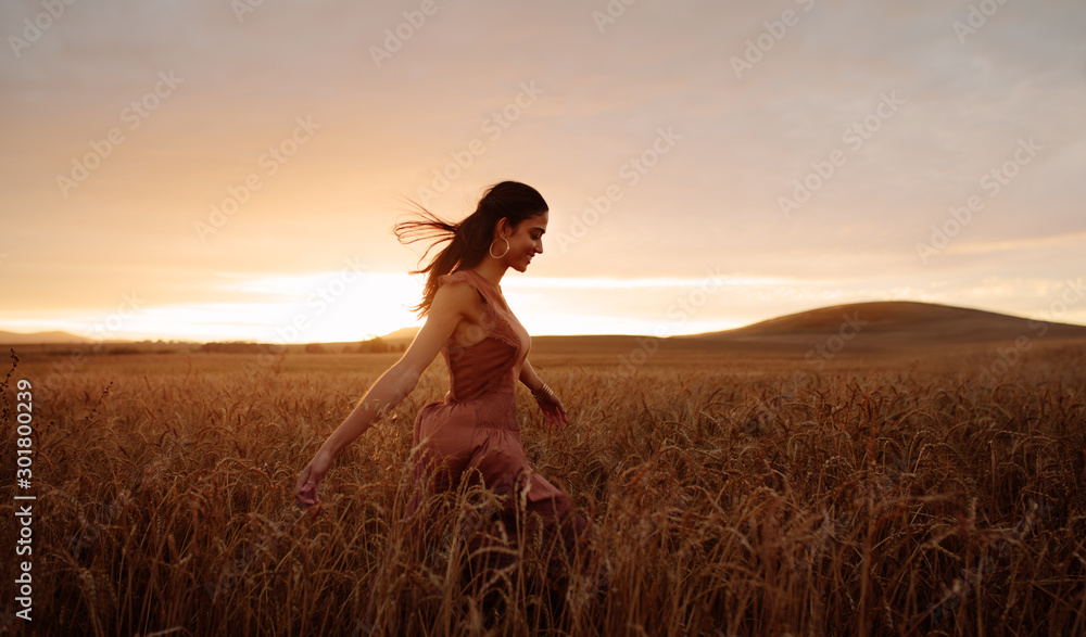 © Jacob Lund - Carefree female strolling in the wheat field