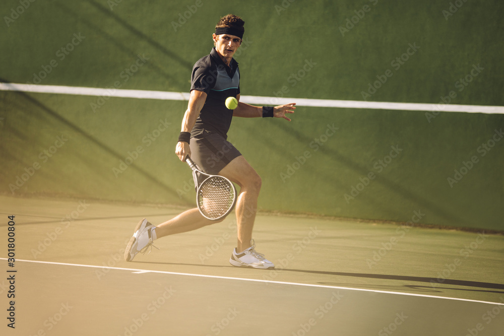 Professional tennis player hitting a strong backhand Professional tennis player hitting a strong backhand