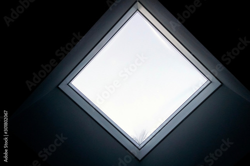 Close up interior view of a real square single window with thick new inner black wall.
