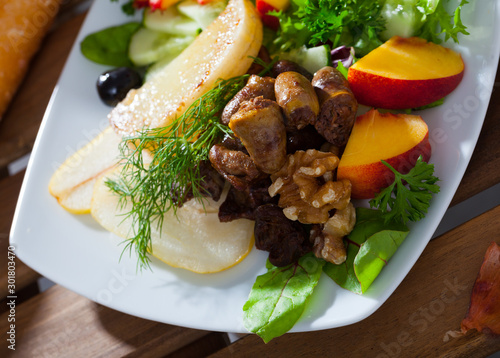 Salad of chicken hearts with peach, pear, fried cheese photo