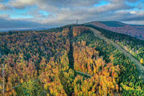 aerial shot of Maple hill with beautifully colored transmitter in autumn colors, Czech , Javorovy vrch photo