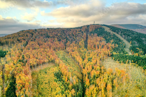 aerial shot of Maple hill with beautifully colored transmitter in autumn colors  Czech   Javorovy vrch