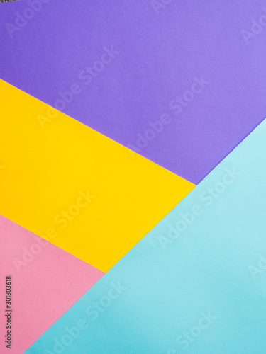 Colorful colored paper background. Multicolor blue, yellow, pink, lilac background. Copy space for text. Abstract pattern can use for design, wallpaper